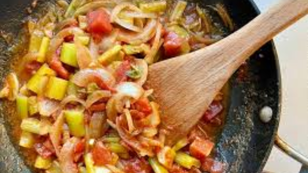 cooking onions tomatoes spices in skillet