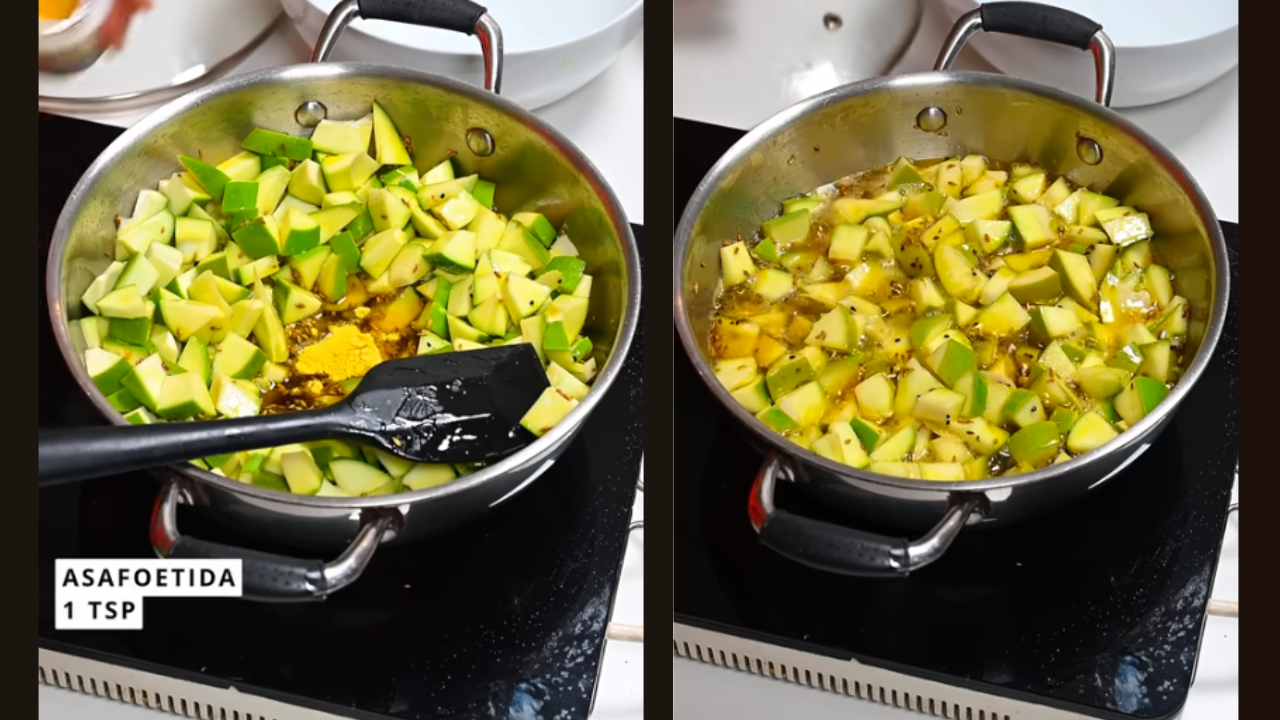 Diced raw mango pieces and softened fenugreek leaves being mixed in the oil.