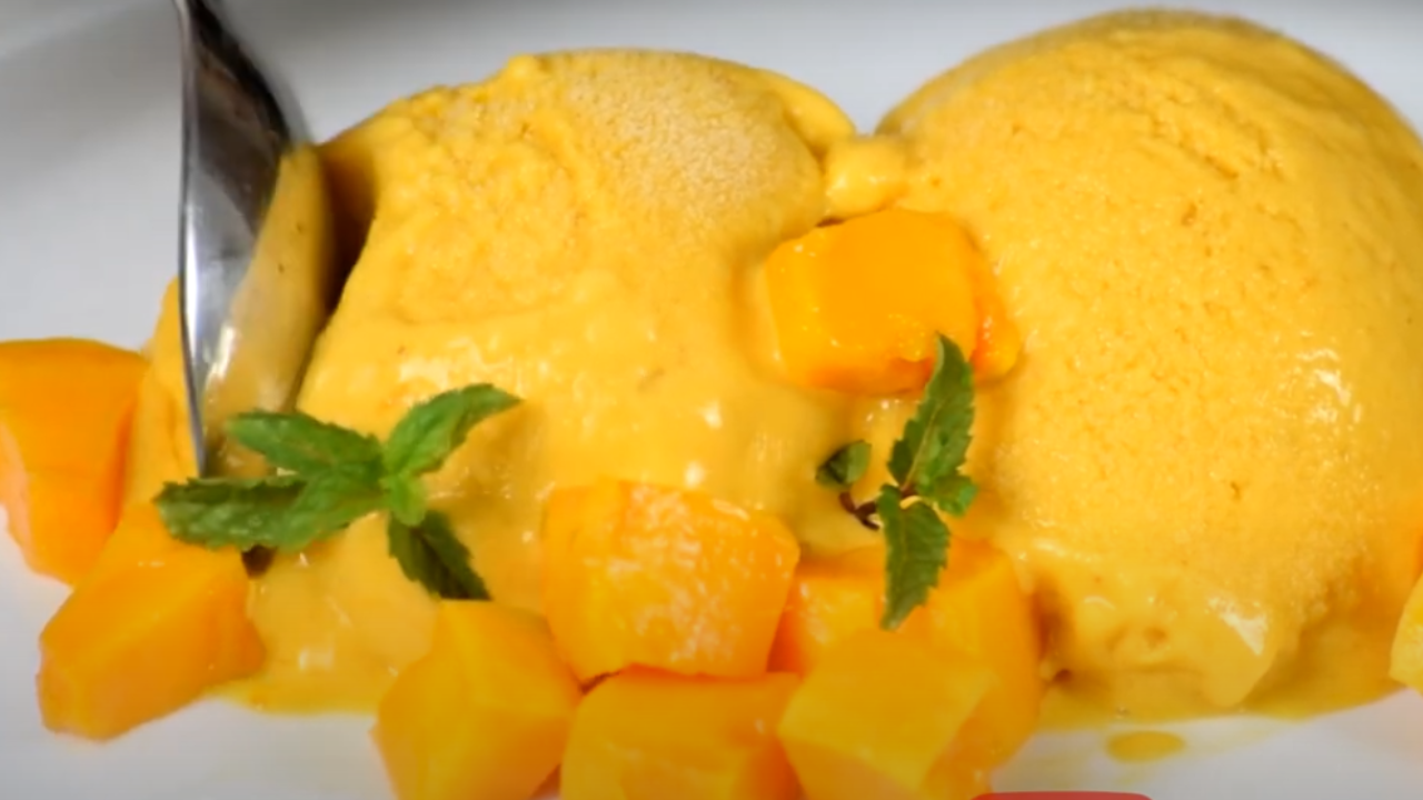 Mango ice cream balls served with mint leaves